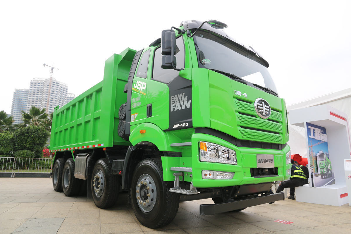 FAW J6P 8×4 dump truck front three quarter view highlighting cabin, multi axle layout and dump body