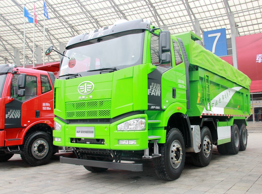 FAW J6P 8×4 dump truck front three quarter view highlighting cabin, multi axle layout and dump body