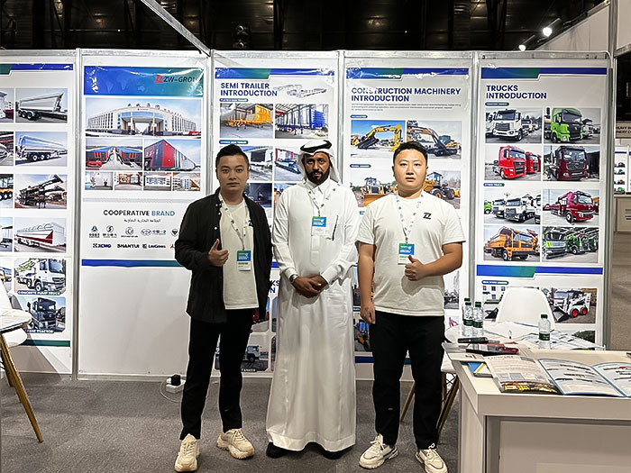ZW Group team with a Saudi client in traditional attire at the Saudi Industrial Exhibition 2025 booth, showcasing complete truck and trailer solutions.