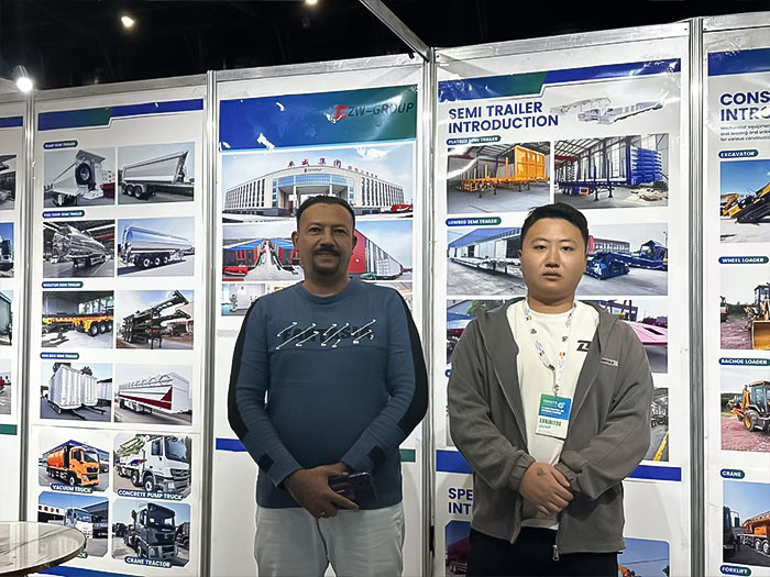 ZW Group representative with a Middle Eastern client at Saudi Industrial Exhibition 2025, discussing semi-trailer introduction.