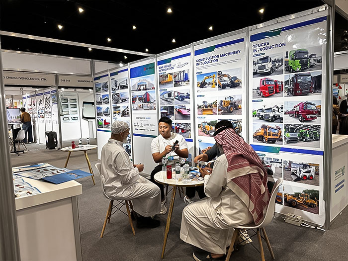 ZW Group representatives in discussion with Saudi clients at their booth at Saudi Industrial Exhibition 2025, discussing transportation and construction machinery solutions.