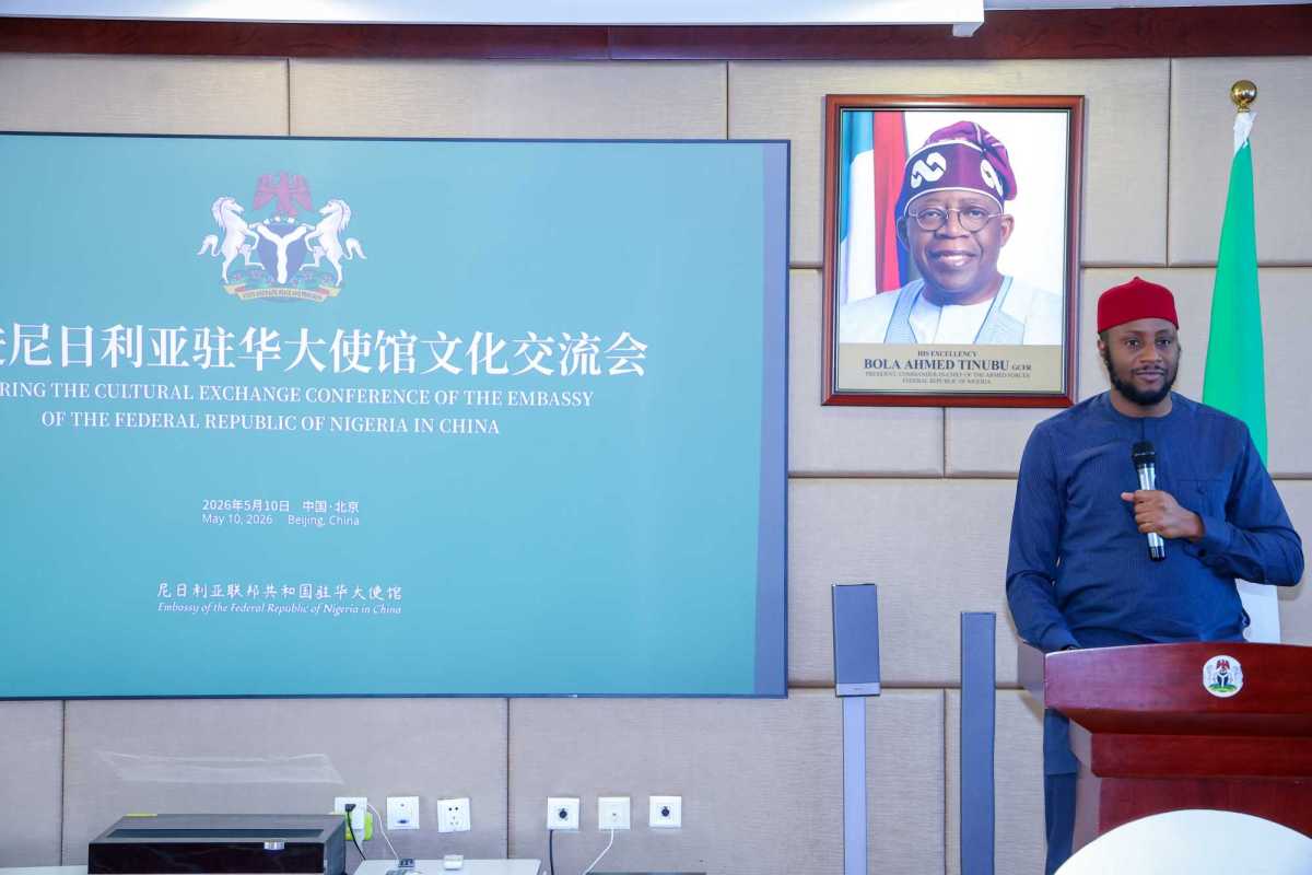 Wide view of the business and cultural exchange conference venue at the Nigerian Embassy in Beijing, showing attendees and official diplomatic backdrops.