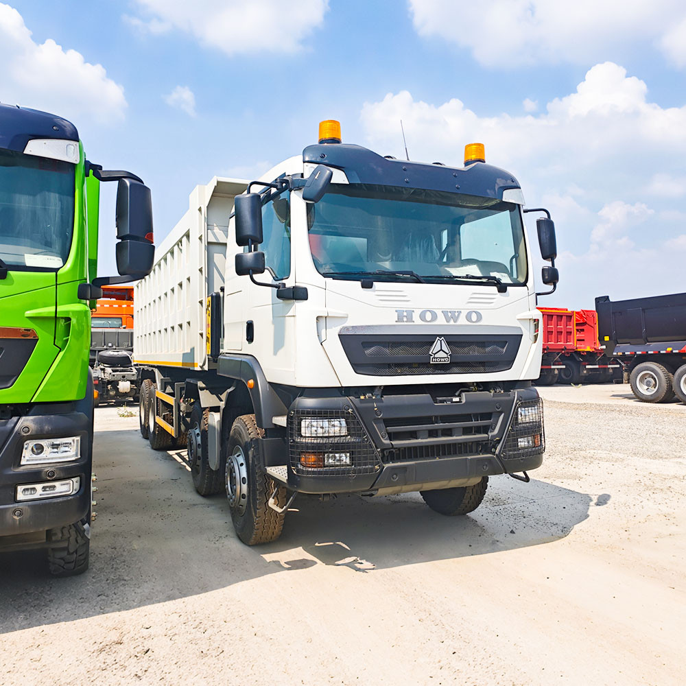Front right perspective of white HOWO TX 400HP 12 wheeler dump truck
