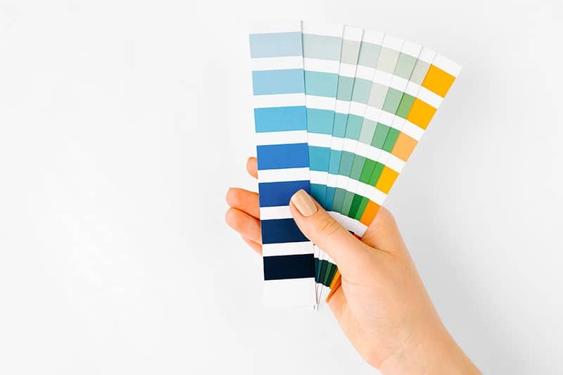 hand holding color pantone swatches Hand holding color pantone swatches