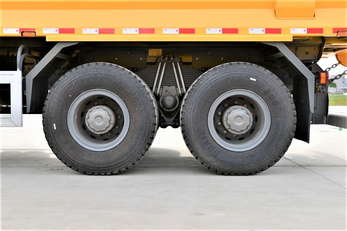 HOWO TX 440HP 8×4 dump truck tire close-up showing heavy-duty off-road tread pattern