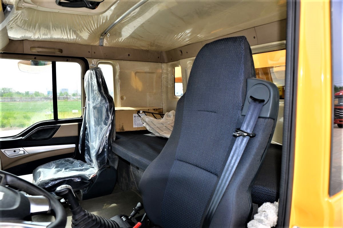HOWO TX 440HP 8x4 dump truck cabin interior close-up showing ergonomic driver seat and dashboard