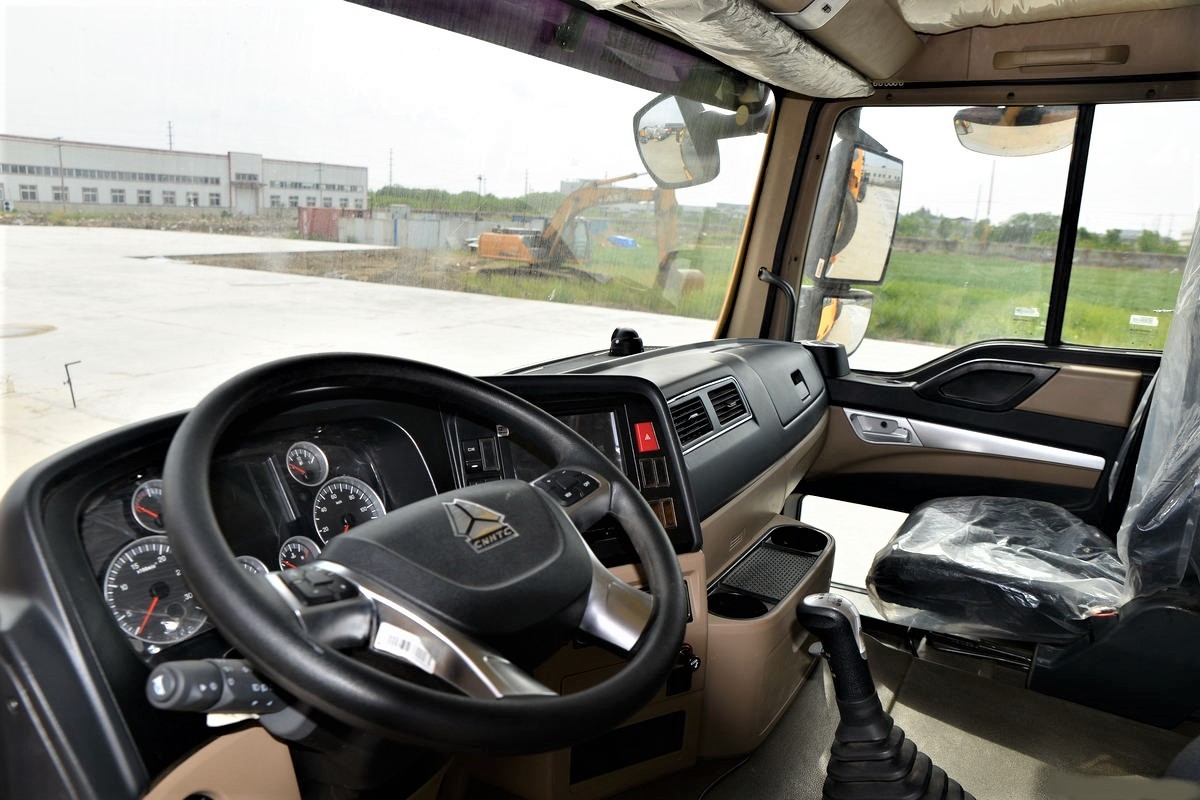 HOWO TX 440HP 8x4 dump truck steering wheel close-up showing controls and operator interface