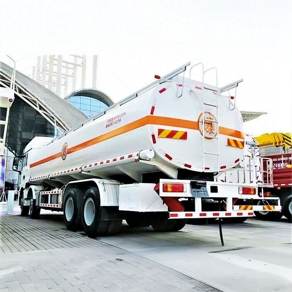 Shacman M3000 8x4 heavy duty fuel tanker truck rear three quarter view showing discharge valve and rear frame