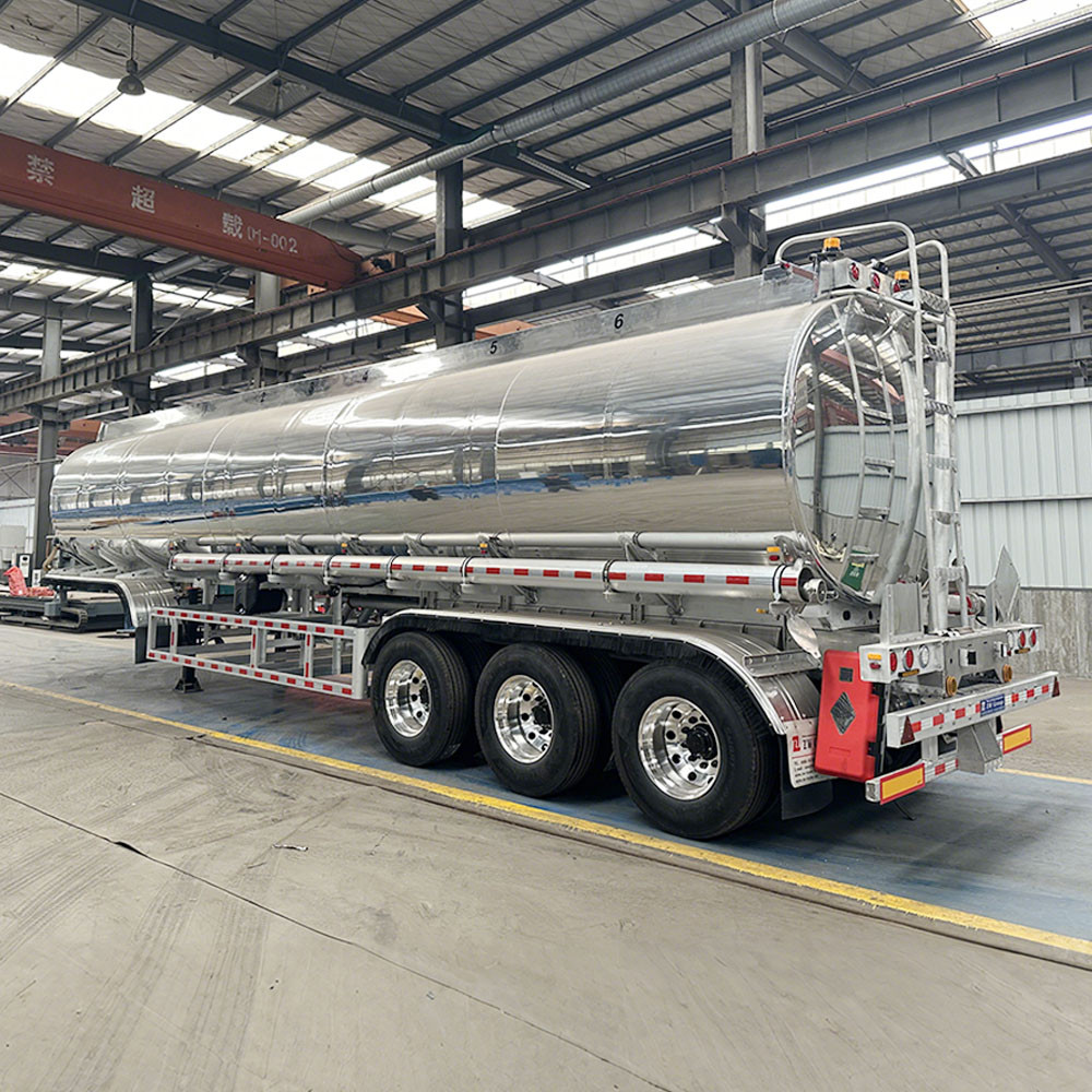 3 axle polished aluminum diesel gasoline tanker semi trailer rear three quarter view showing discharge system and rear platform