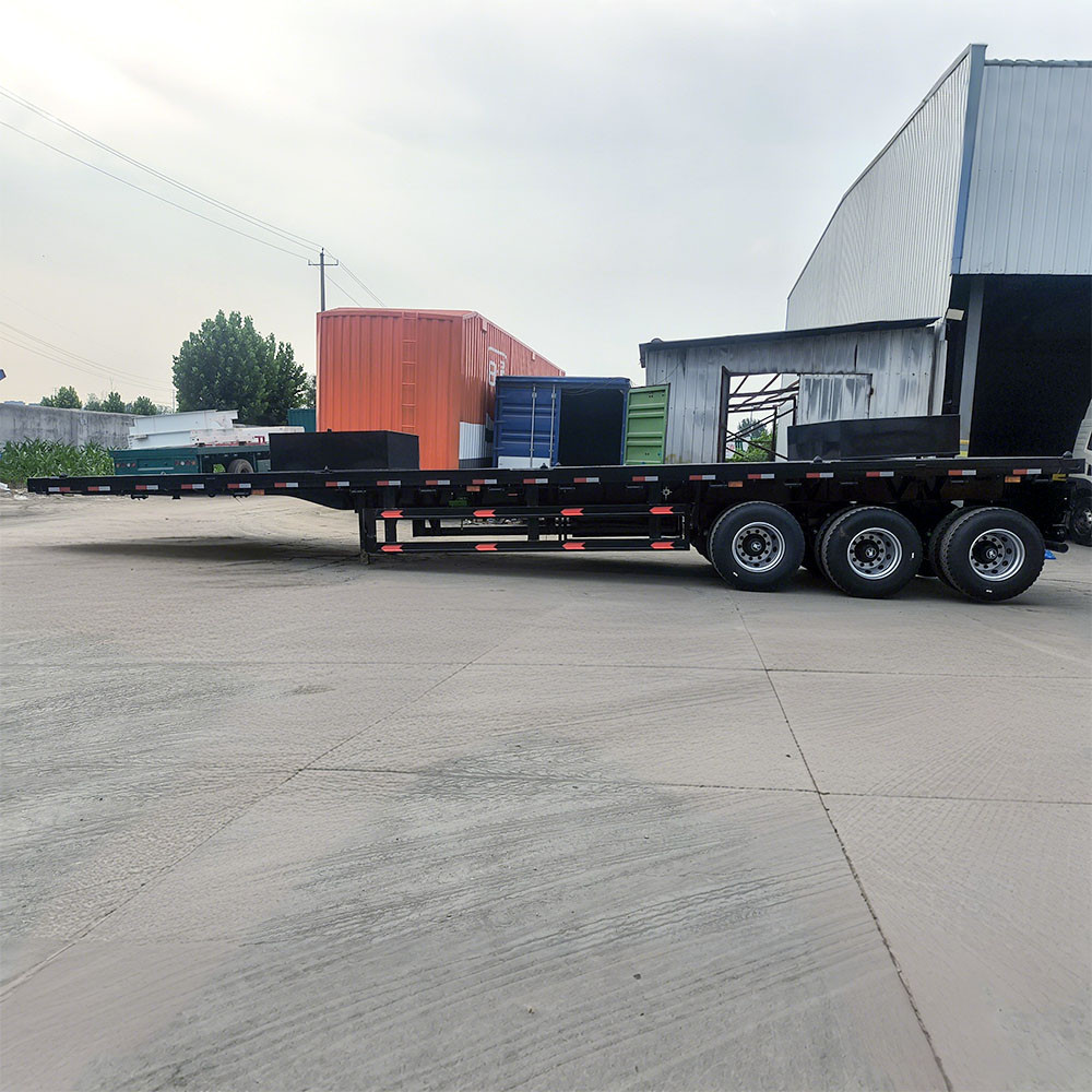 3 axle flatbed semi trailer side view showing long flat deck for container and steel transport