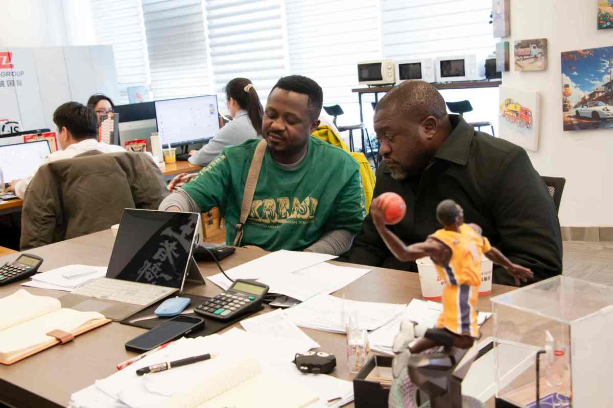 Client and ZW Sales Representative Discussing Fuel Tanker Trailer Technical Parameters and Custom Configurations at Office Desk