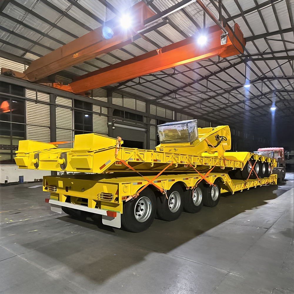4 axle 100 ton removable gooseneck lowboy trailer rear three quarter view showing heavy-duty loading ramps and rear frame