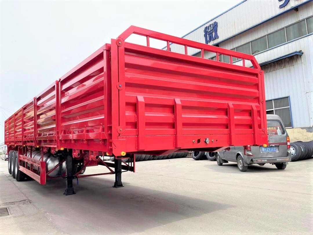 3 axle side wall cargo trailer front three quarter view highlighting side wall panels and three axle layout
