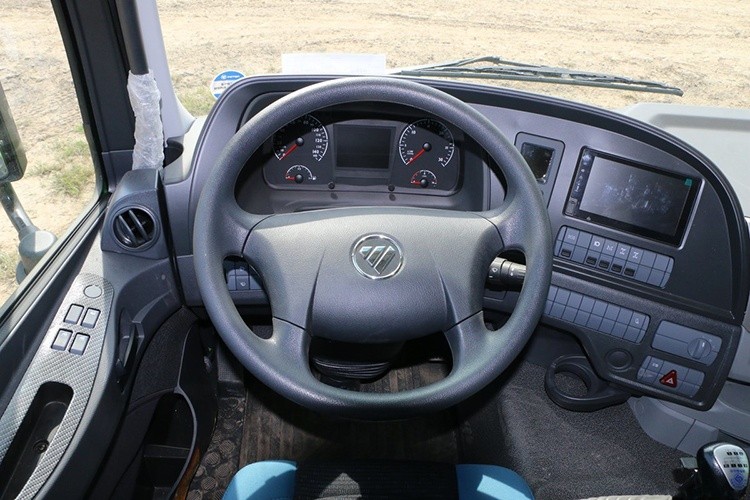 truck steering wheel detail showing ergonomic design, horn, and control buttons