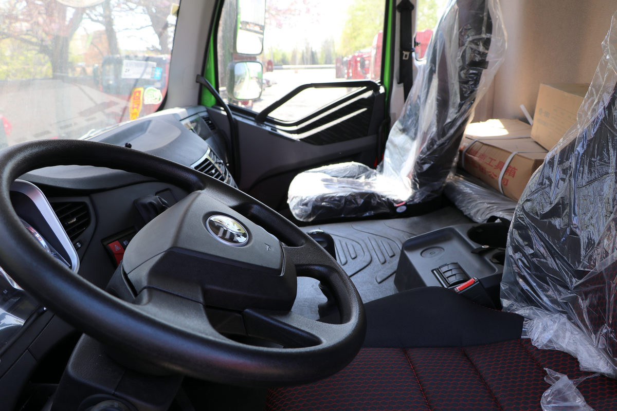 FAW J6P dump truck cabin interior detail showing steering wheel, dashboard and driver control system