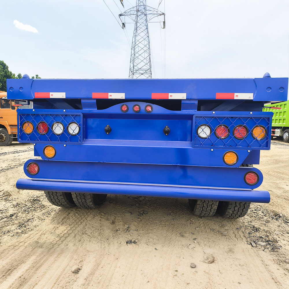 Rear view of 40ft flatbed semi trailer showing tail lights and bumper protection