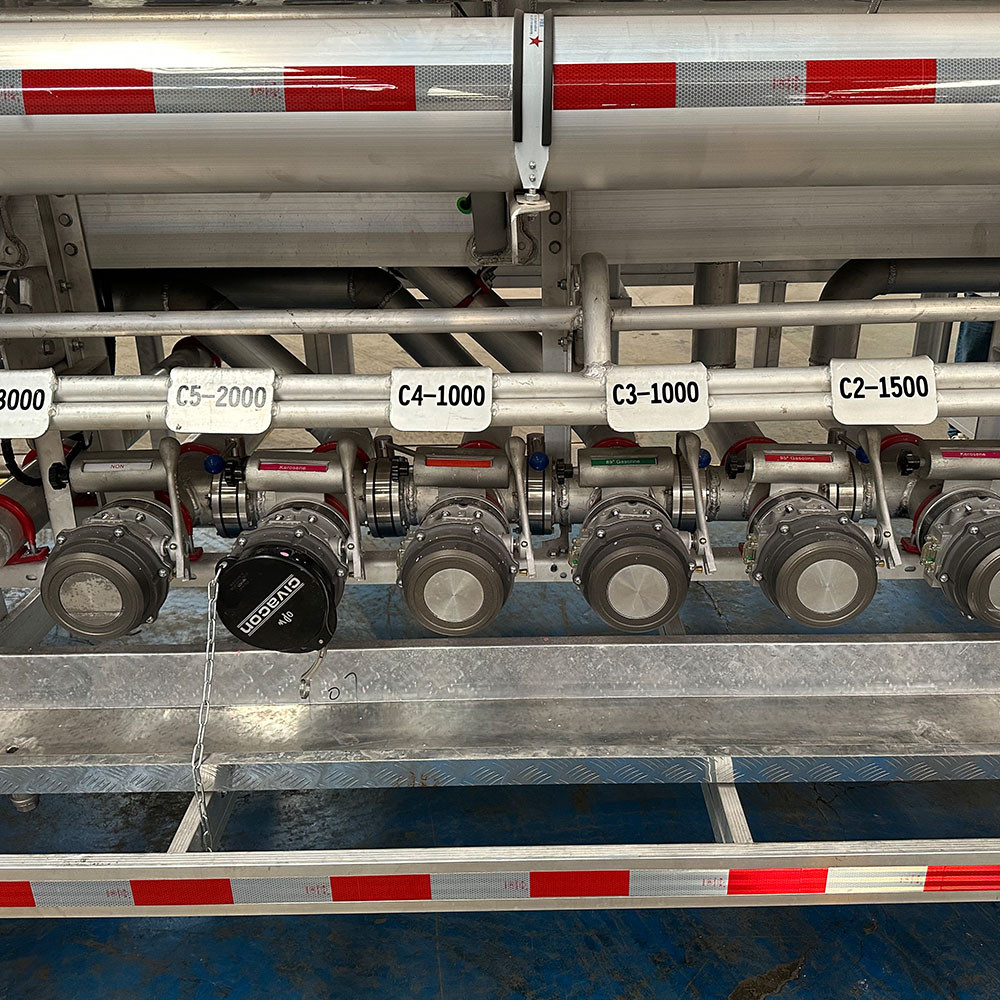 3 axle polished aluminum diesel gasoline tanker semi trailer valve box detail showing bottom loading and unloading system