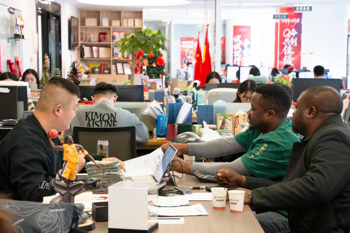 Client and ZW Sales Representative Discussing Fuel Tanker Trailer Technical Parameters and Custom Configurations at Office Desk