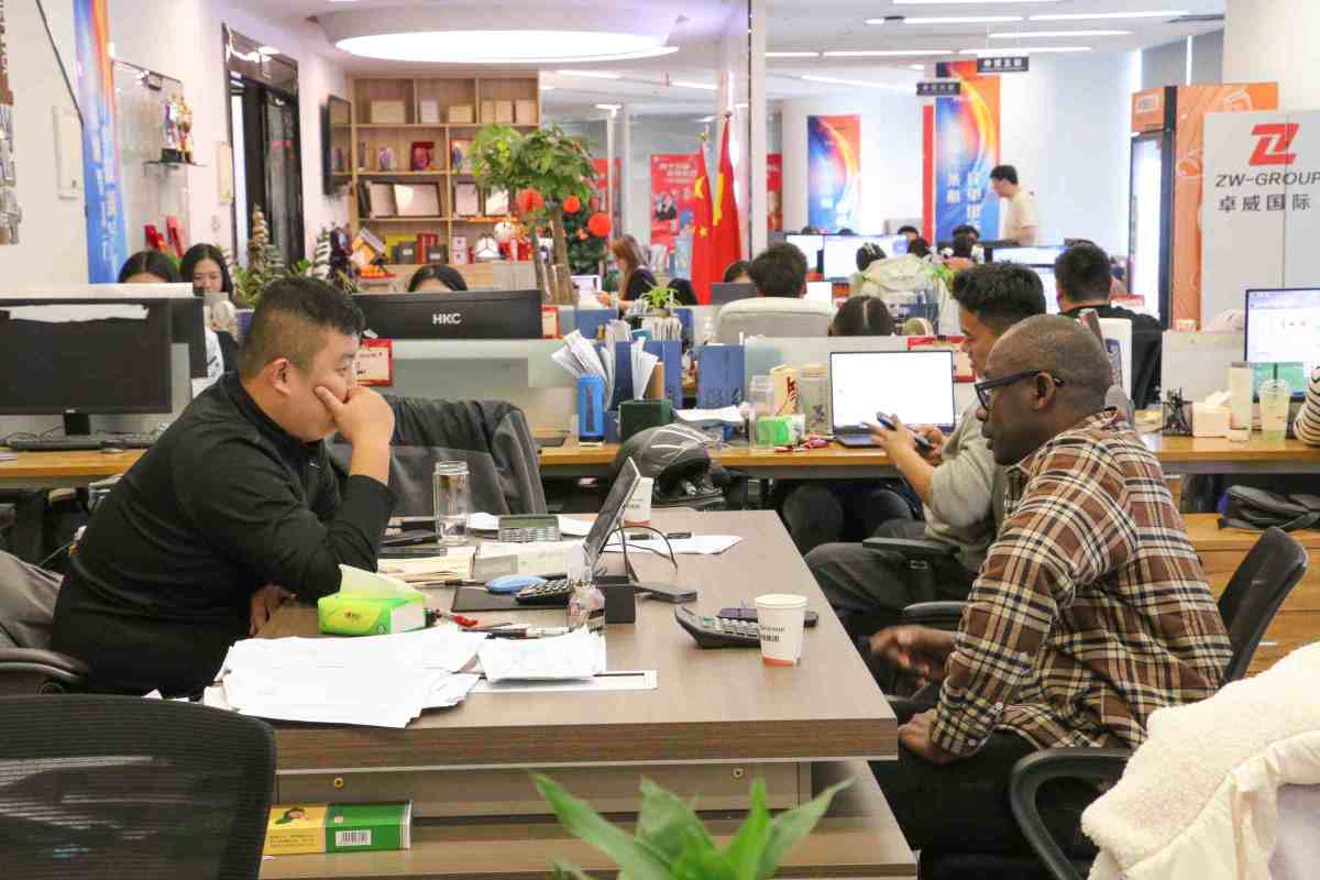 Senegalese transport operators discussing ZW Flatbed Trailers and HOWO Trucks' technical specifications, highlighting key factors like cargo capacity, fuel efficiency, and operational uptime.