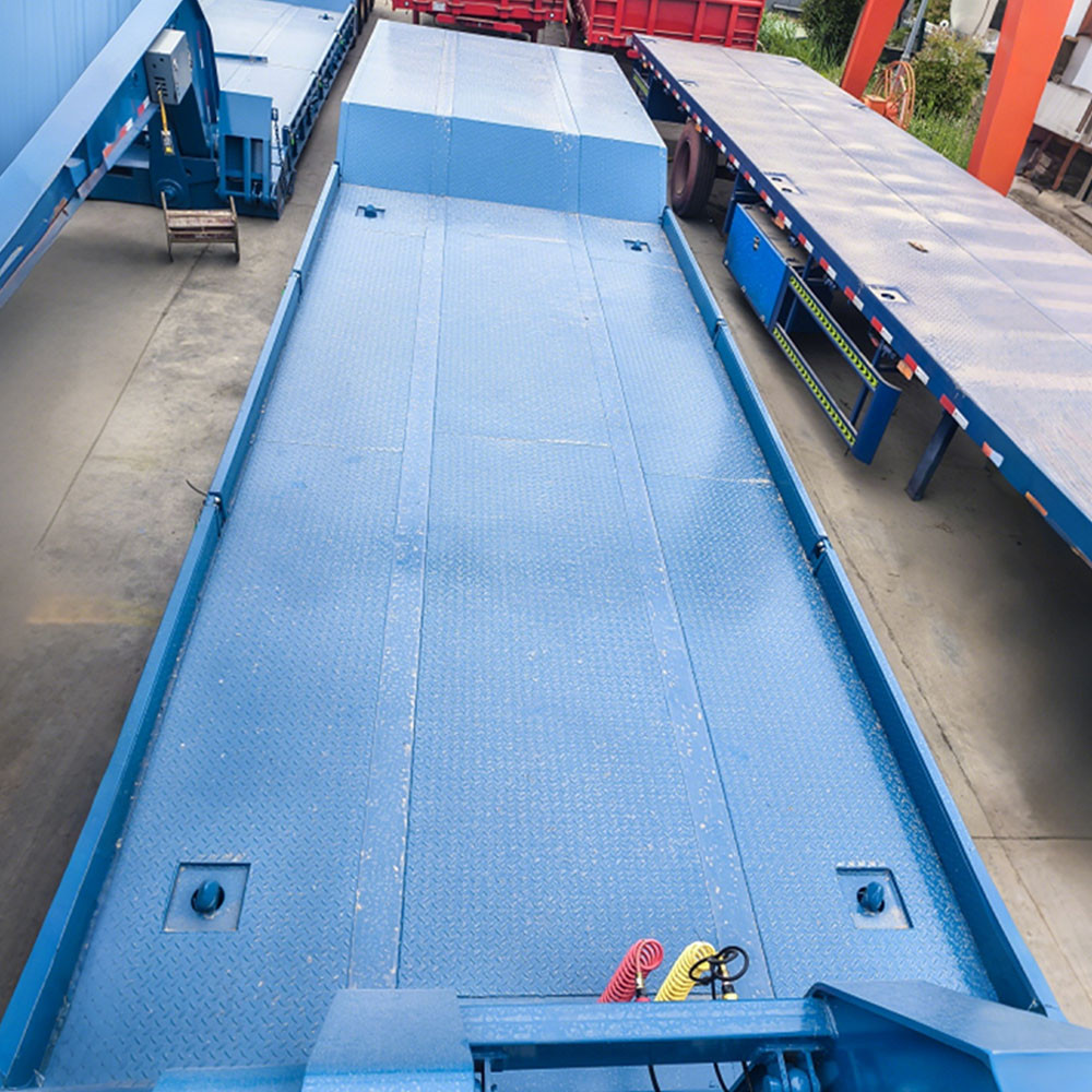 3 axle 60 ton RGN lowboy trailer low deck detail showing high-strength steel platform for heavy machinery