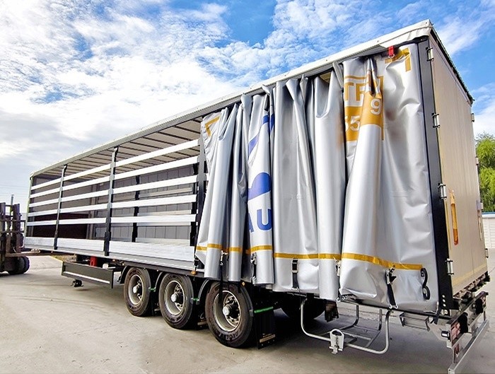Dry van curtain semi trailer side view showing long cargo deck and enclosed dry van curtain panels