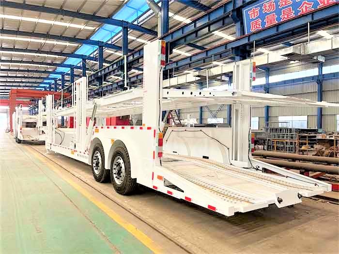 2 axle double deck car carrier trailer front three quarter view highlighting double deck structure and axle layout