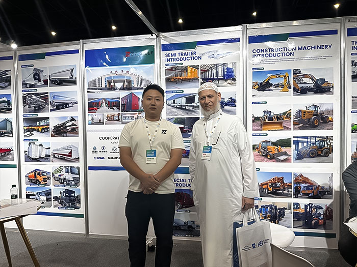 ZW Group team member with an honored Saudi guest at the Saudi Industrial Exhibition 2025 booth, showcasing a wide range of heavy vehicle and machinery solutions.