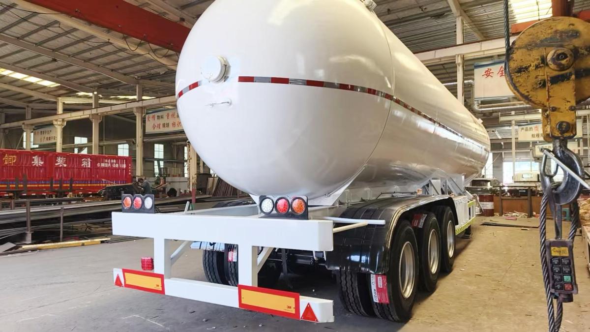 Rear view of propane gas tanker trailer showing safety bumper and tail lights