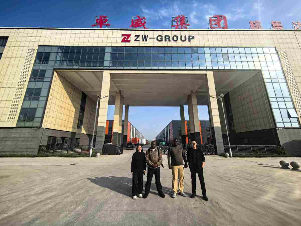 ZW Group CEO Ivan Sun (Sun Yongchang), Foreign Trade Manager, and Congo Clients at ZW Factory Entrance for a Group Photo