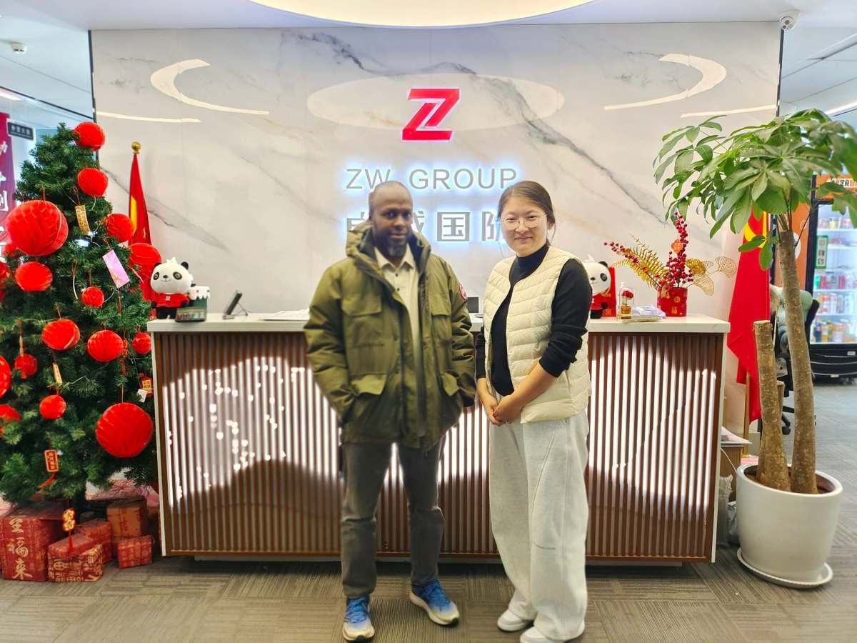 Congo Clients and ZW Group Sales Representative Posing for a Photo at the Company Entrance After Factory Tour