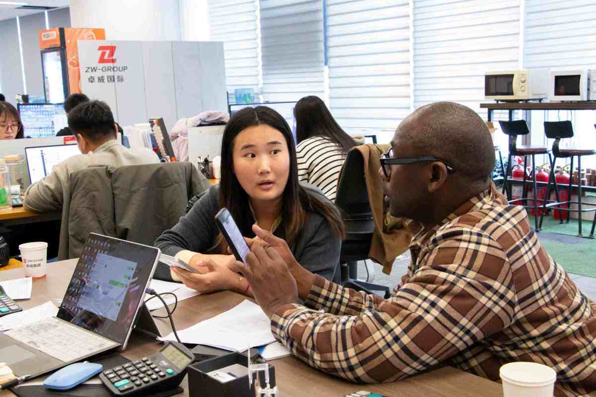 Senegalese transport operators discussing ZW Flatbed Trailers and HOWO Trucks' technical specifications, highlighting key factors like cargo capacity, fuel efficiency, and operational uptime.