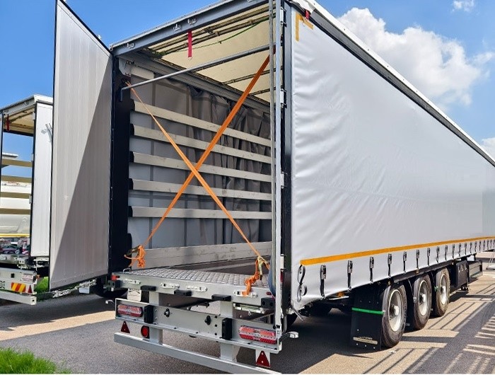 Dry van curtain semi trailer rear view showing rear cargo access and locking system