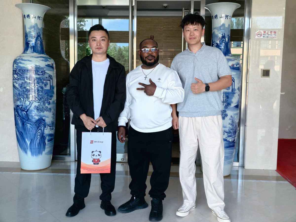 Shandong ZW Vehicle Group representatives Charles and Damon with a Nigerian business partner, showcasing long-term cooperation and professional service.