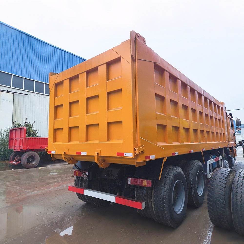 Shacman F3000 380HP 8x4 dump truck rear three quarter view showing dump body tilt and chassis