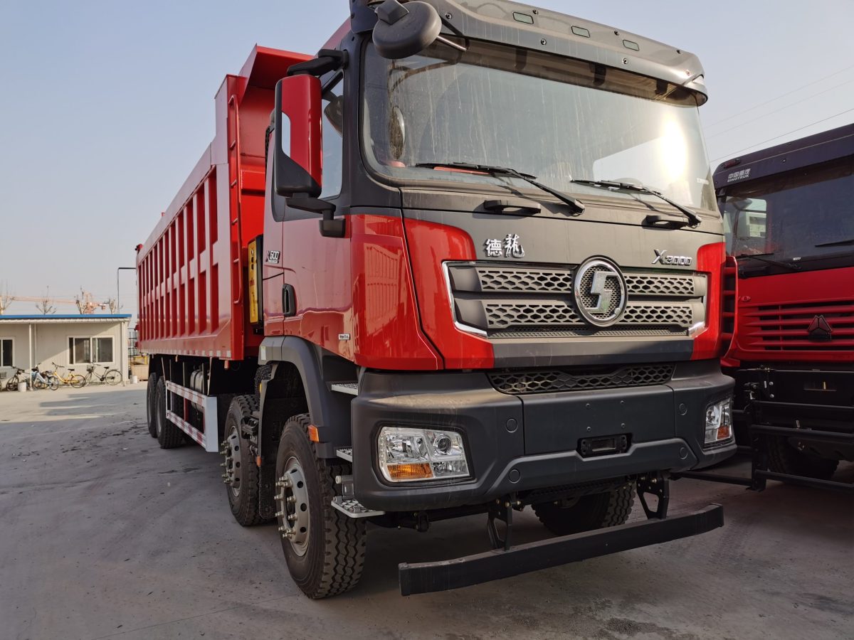 Shacman X3000 8x4 heavy duty dump truck front three quarter view highlighting dump body and chassis structure