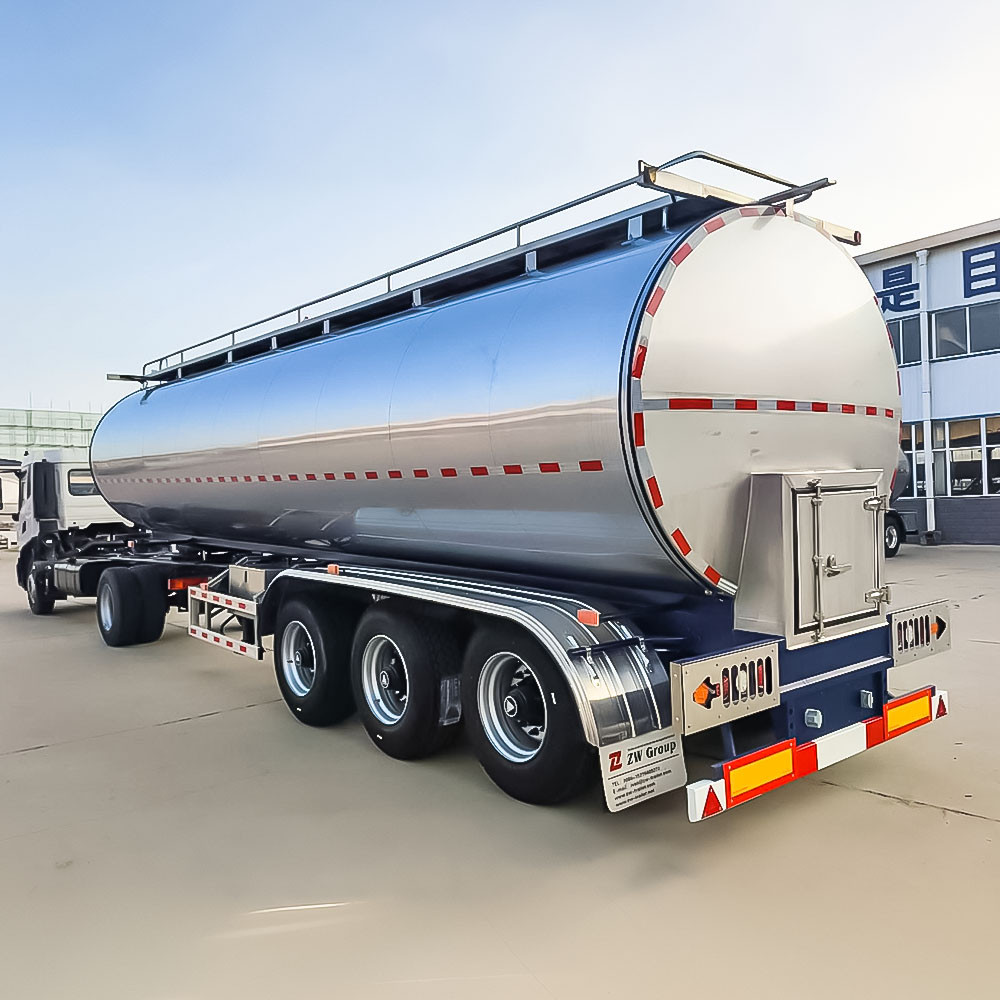 3 axle stainless steel milk tanker rear three quarter view showing discharge valves and rear platform