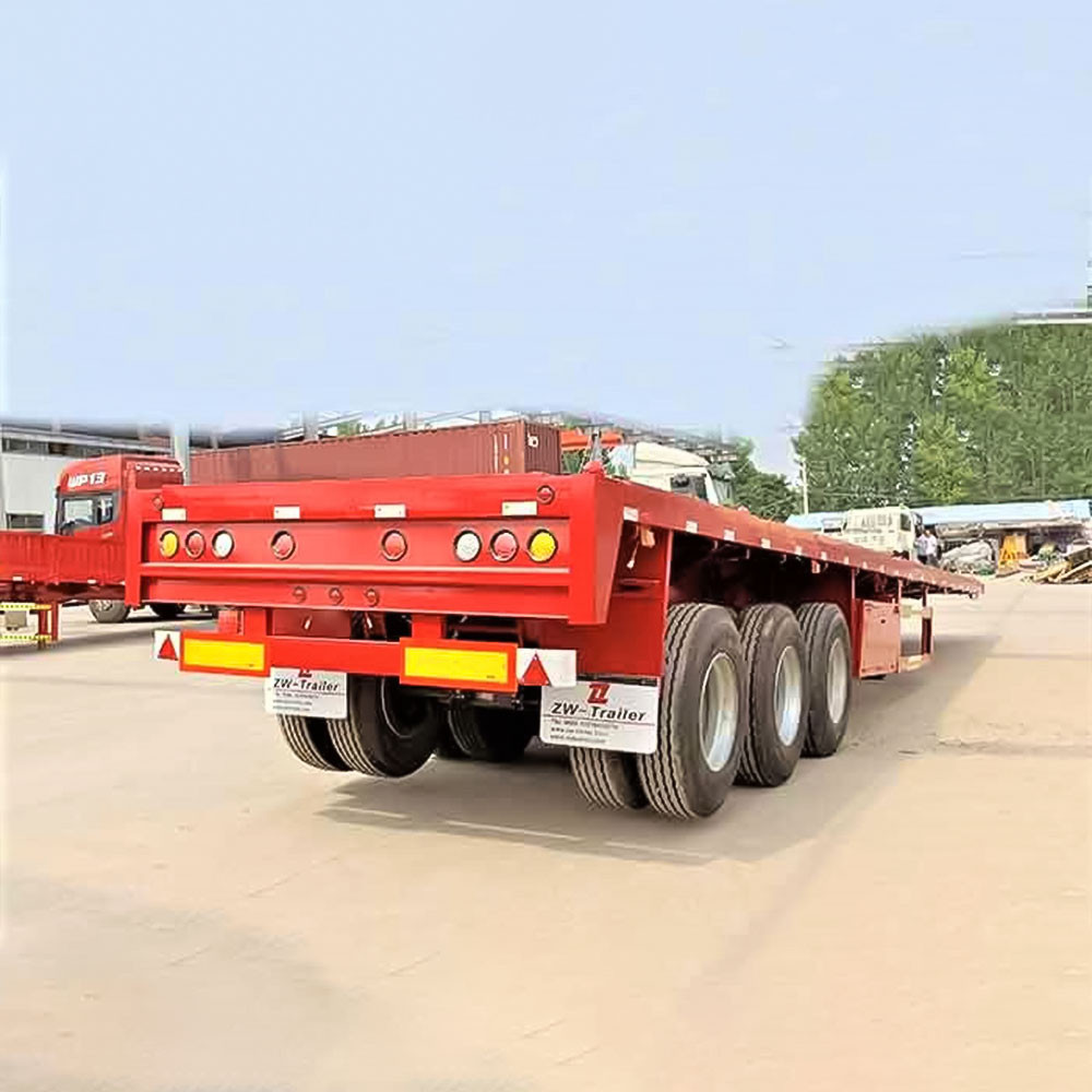 3 axle flatbed semi truck trailer rear three quarter view showing rear structure and lighting system