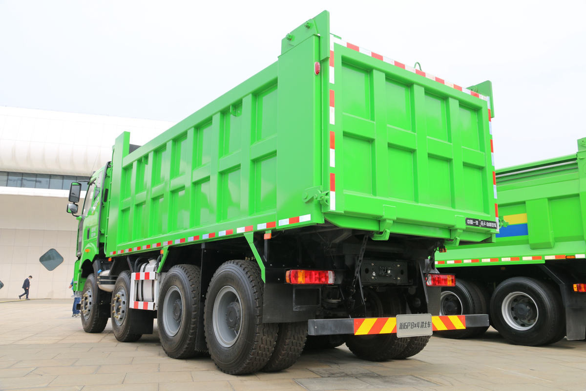 FAW J6P 8×4 dump truck rear three quarter view showing tailgate and hydraulic lifting system