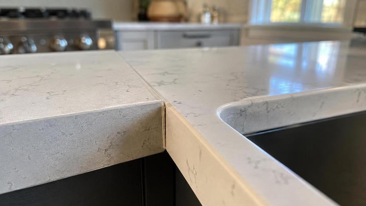 Close-up of a quartz countertop edge and sink area after cleaning Close-up of a quartz countertop edge and sink area after cleaning