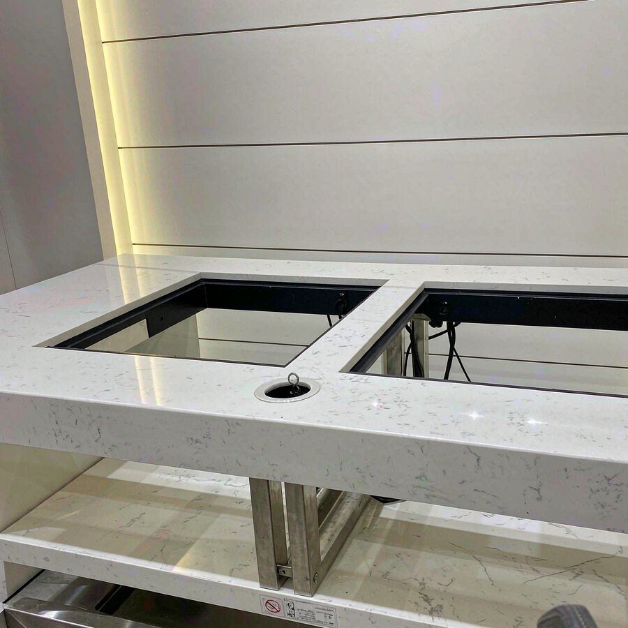 1789378673958057357057687552.png Commercial quartz checkout countertop with equipment cutouts and cable access points
