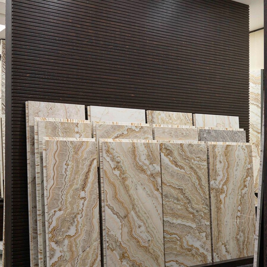 Consistent engineered quartz slab color across a showroom wall
