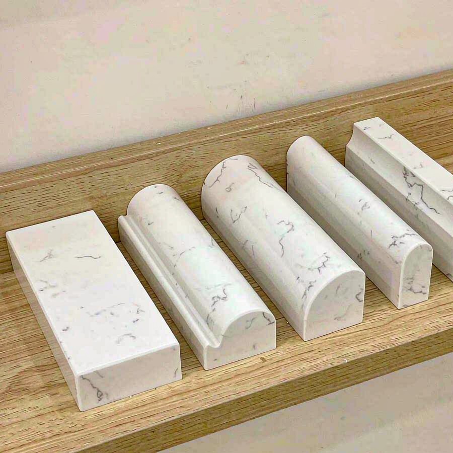 Row of polished edge profile samples of cut quartz slabs