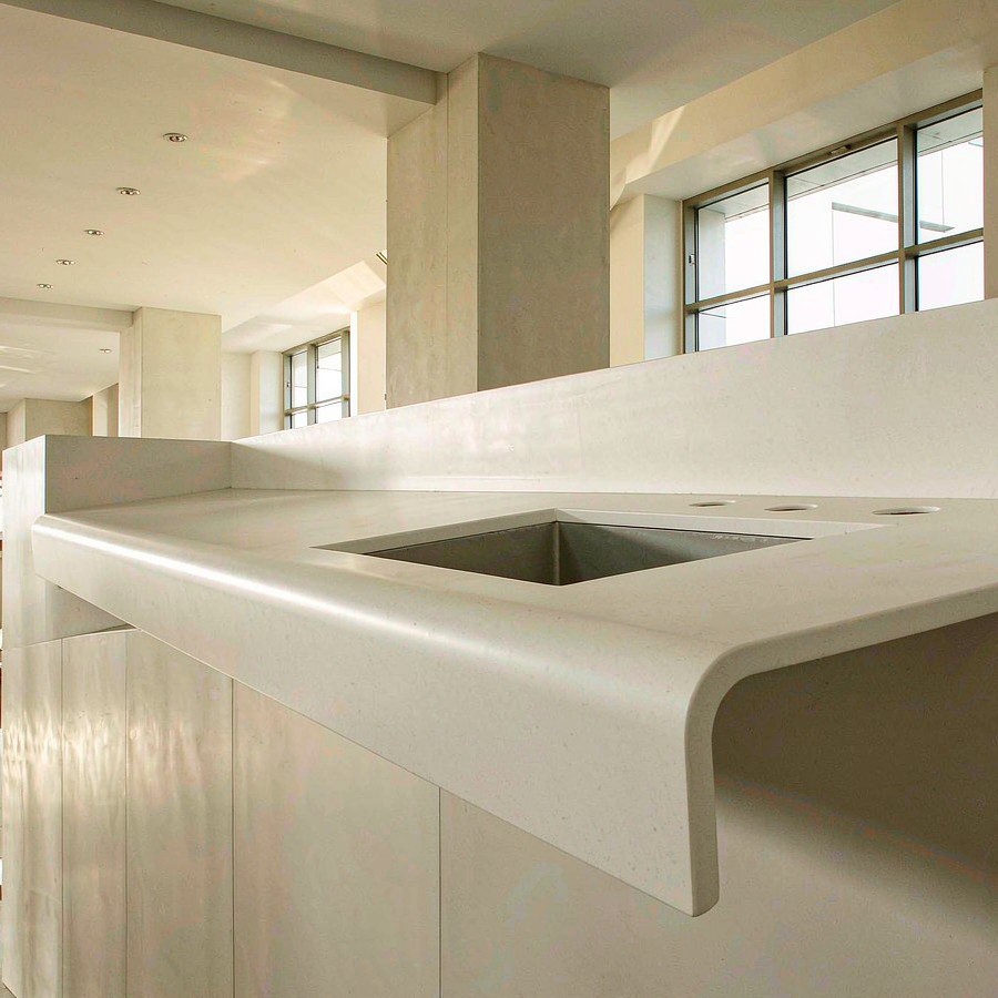 Custom cut quartz countertop with sink and faucet cutouts on a reception counter