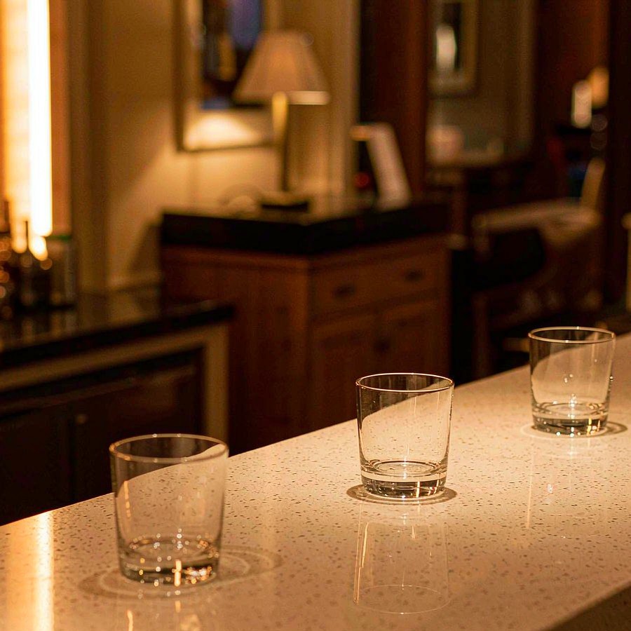Hotel bar counter with waterproof quartz stone top and water glasses resting on the surface