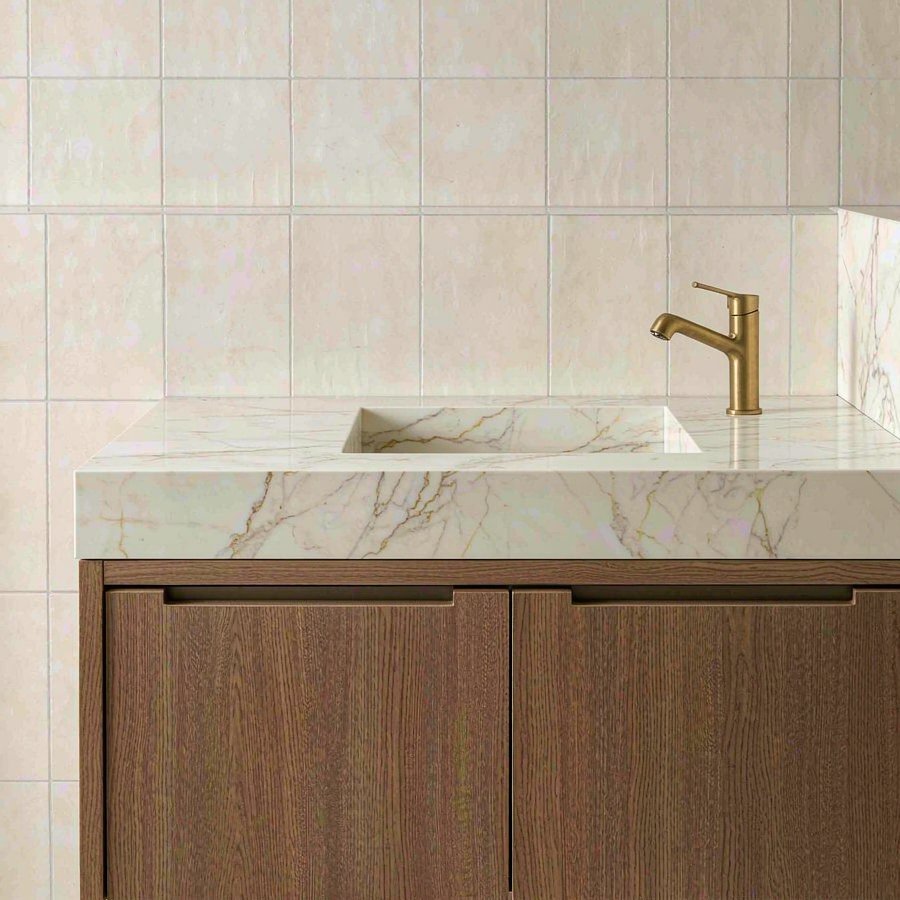 1789896184960227952327991296.jpg Bathroom vanity with warm white engineered quartz countertop, integrated sink and matching backsplash