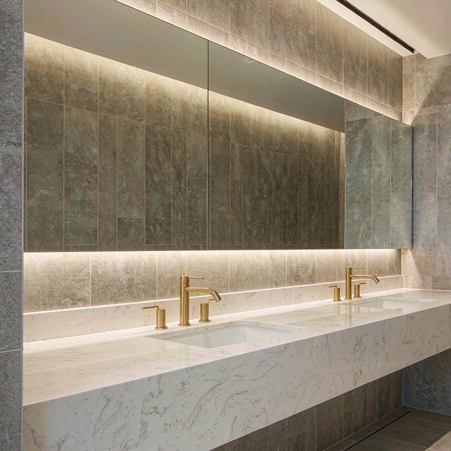 1790236834961656742380331008.jpg Commercial washroom vanity run fabricated from engineered quartz slabs in a hotel project