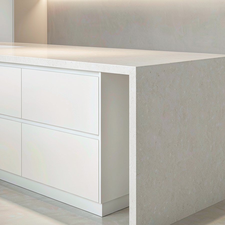 Modern kitchen island with a white quartz waterfall edge dropping vertically to the floor