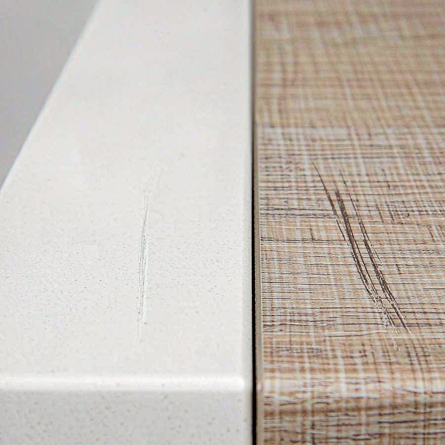 Close up durability test showing quartz and laminate surface after scratch impact