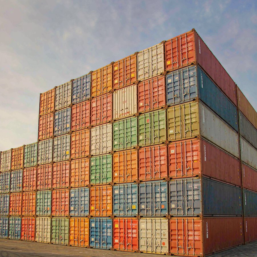Containers stacked at a container yard — the freight leg a quartz slab FOB buyer arranges