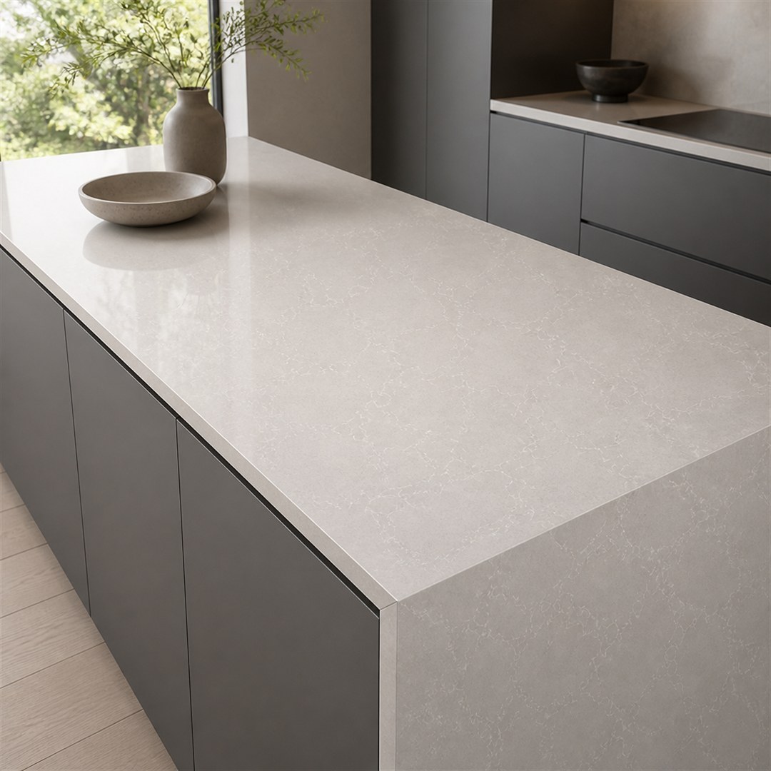 1792129794969596392455852032.jpg White quartz countertop with undermount sink and flat waterfall edge in a residential kitchen